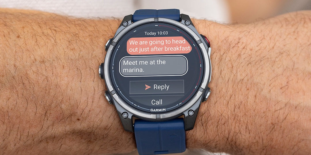 Garmin quatix 8 Pro nautical smartwatch on wrist, receiving a marina text message